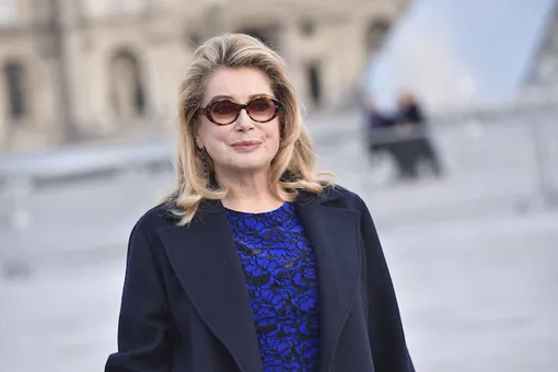 Великолепная 73-летняя Катрин Денев в платье миди и кожаной куртке в Париже